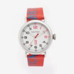 Nautica N83 men's sustainable watch with red canvas strap and bold blue N83 logo, white dial with black and red numerals – model NAPLSS004